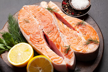 Fresh raw salmon cooking. Fish steaks with herbs and spices