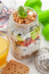 Healthy breakfast with jar of granola, yogurt and fresh berries