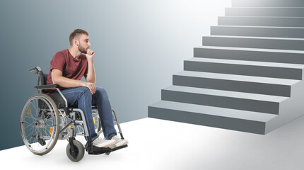 Sad young man in wheelchair near drawn stairs