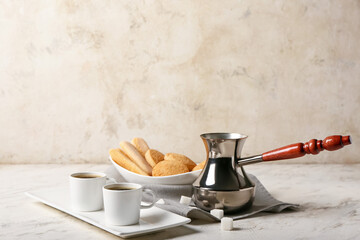 Composition with cups of tasty coffee and cookies on light background