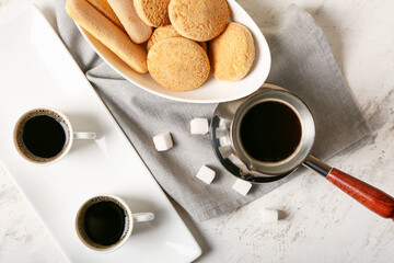 Composition with cups of tasty coffee and cookies on light background