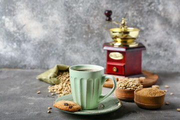 Composition with cup of tasty coffee and beans on grey background