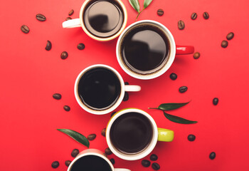 Cups of tasty coffee and beans on color background