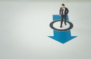 Miniature businessman leader standing on arrow and go to way go ahead