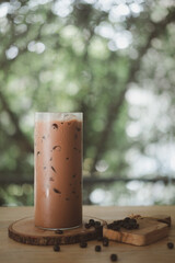 Iced coffee Mocha in a tall glass with coffee beans.