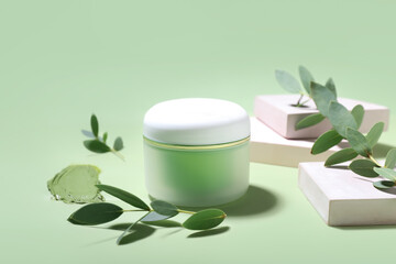 Composition with jar of cosmetic clay on color background