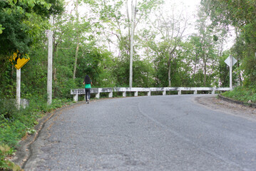 Walking Asian kids girl walking exercise on a mountain road