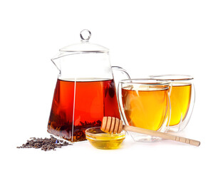 Teapot with hot tea, glasses, dry leaves and honey on white background