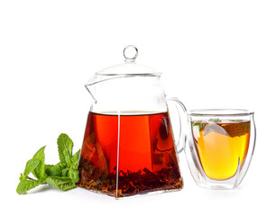 Teapot with hot tea, glass and mint on white background