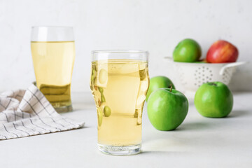 Glasses of cold apple cider on table