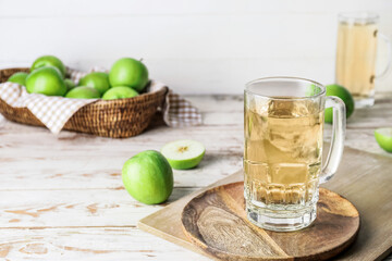 Board with mug of apple cider on table