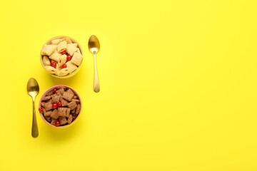 Bowls with tasty corn pillows and cranberries on color background