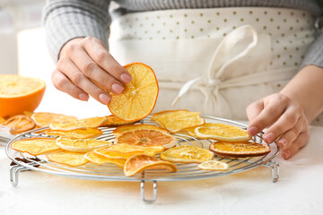 Woman with dried orange slices on light table