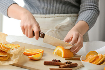 Woman cutting orange at table