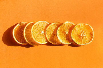 Dried orange slices on color background