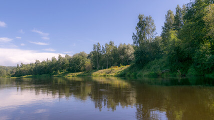 Fototapeta na wymiar beautiful morning on the river, shore and tree reflections in the water, Gauja river, Latvia