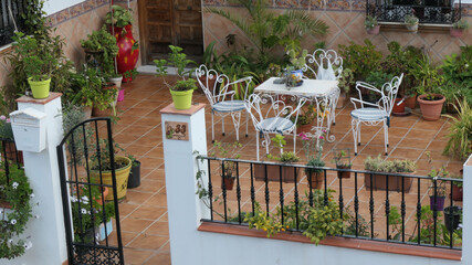 Idyllic outdoor tiled terrace with table and chairs