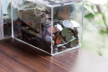 Money, coins and notes put in boxes placed on the table