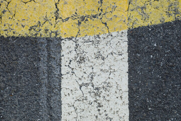 White and yellow lines on a grey asphalt street,, space for text, no person