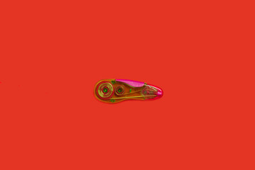plastic tape corrector on a red background