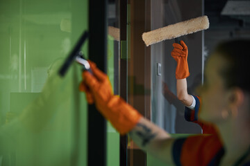 Workers using a microfiber scrubber and a squeegee during the clean-up