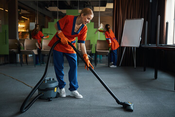 Janitorial staff tidying up the conference room