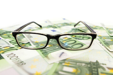 100 euro banknotes and glasses.Close-up