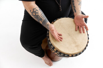 fat funny caucasian bearded man withh tattoes and drum