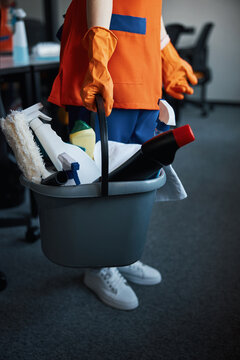 Janitor With Janitorial Supplies Standing On The Carpet Flooring