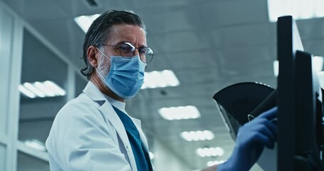 Serious scientist using computer in lab
