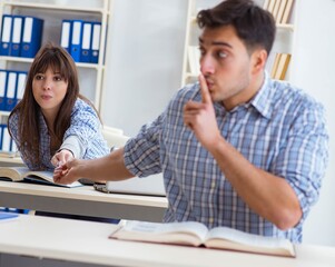 Students sitting and studying in classroom college