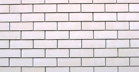 light brick wall made of white blocks with dark cement joints full frame, plain brickwork backdrop, gray block background graphic resource