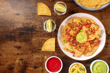 Nachos, Mexican tortilla chips, shot from the top on a rustic wooden background
