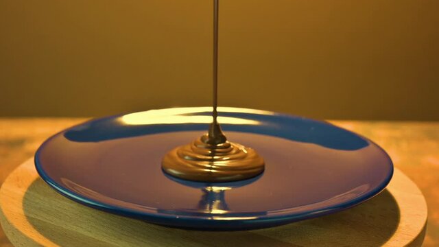 chocolate paste with hazelnuts on a beautiful background pours onto the rotating