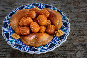 Tulumba tatlısı or bamiyeh dessert and taş kadayıf or atayef on the table at ramadan dinner