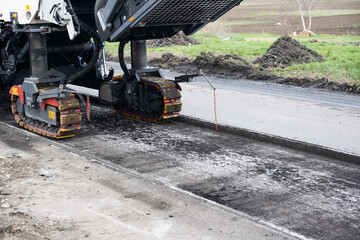 repair of an asphalt road with fresh asphalt