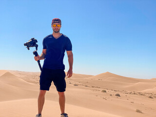 Filmmaker Shooting in the Desert Sand Dunes