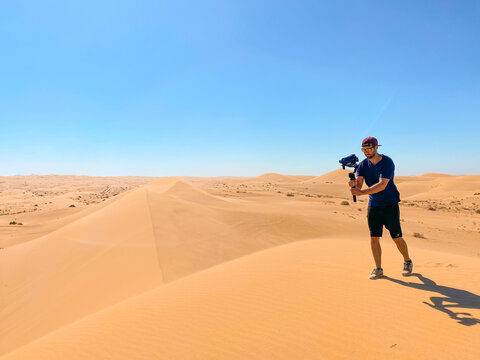 Filmmaker Shooting in the Desert Sand Dunes