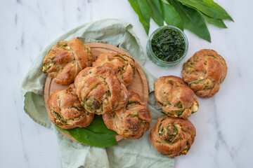 home made whole grain bread rolls with wild garlic on a table