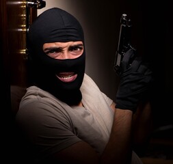 Burglar wearing balaclava mask at crime scene