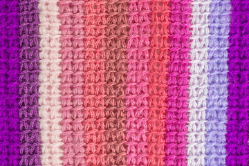 striped background of tunisian crochet fabric in basic stitch in shades of pink and purple - 428728252