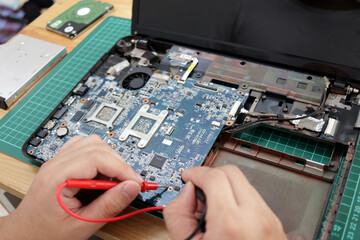 Close up of technician engineer trying to repairing broken laptop. Computer repairs and upgrade