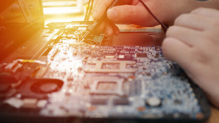 Close up of technician engineer trying to repairing broken laptop. Computer repairs and upgrade