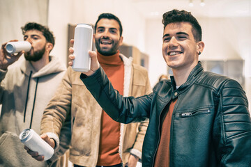 Youth drink culture. Generation z people having fun on the street drinking canned alcoholic drinks or beer on white canned blank package, ideal for mockups. Urban lifestyle filtered. Focus on the can.