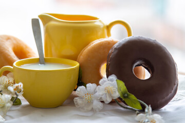 delicious donuts with cup of milk on the table