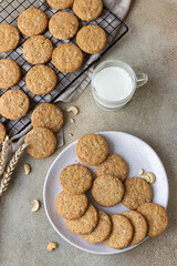 Oatmeal cookies with cereals, seeds and nuts, concrete background. Healthy vegan cookies. Top view.