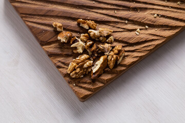 Walnut kernels on rustic board. Concept of healthy food and vegetarianism