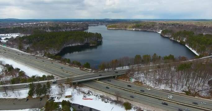 Aerial view of Lake Cochituate and Interstate Highway 90 in winter with snow in Cochituate State Park in town of Natick, Massachusetts MA, USA. 