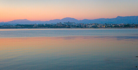 Fototapeta na wymiar The tourist resort of Side, a panorama after sunset with a calm Mediterranean Sea, Turkey.