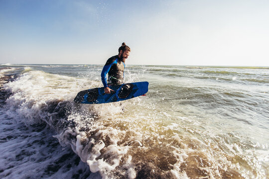 Surfer man with surf board on the beach. Summer sport activity